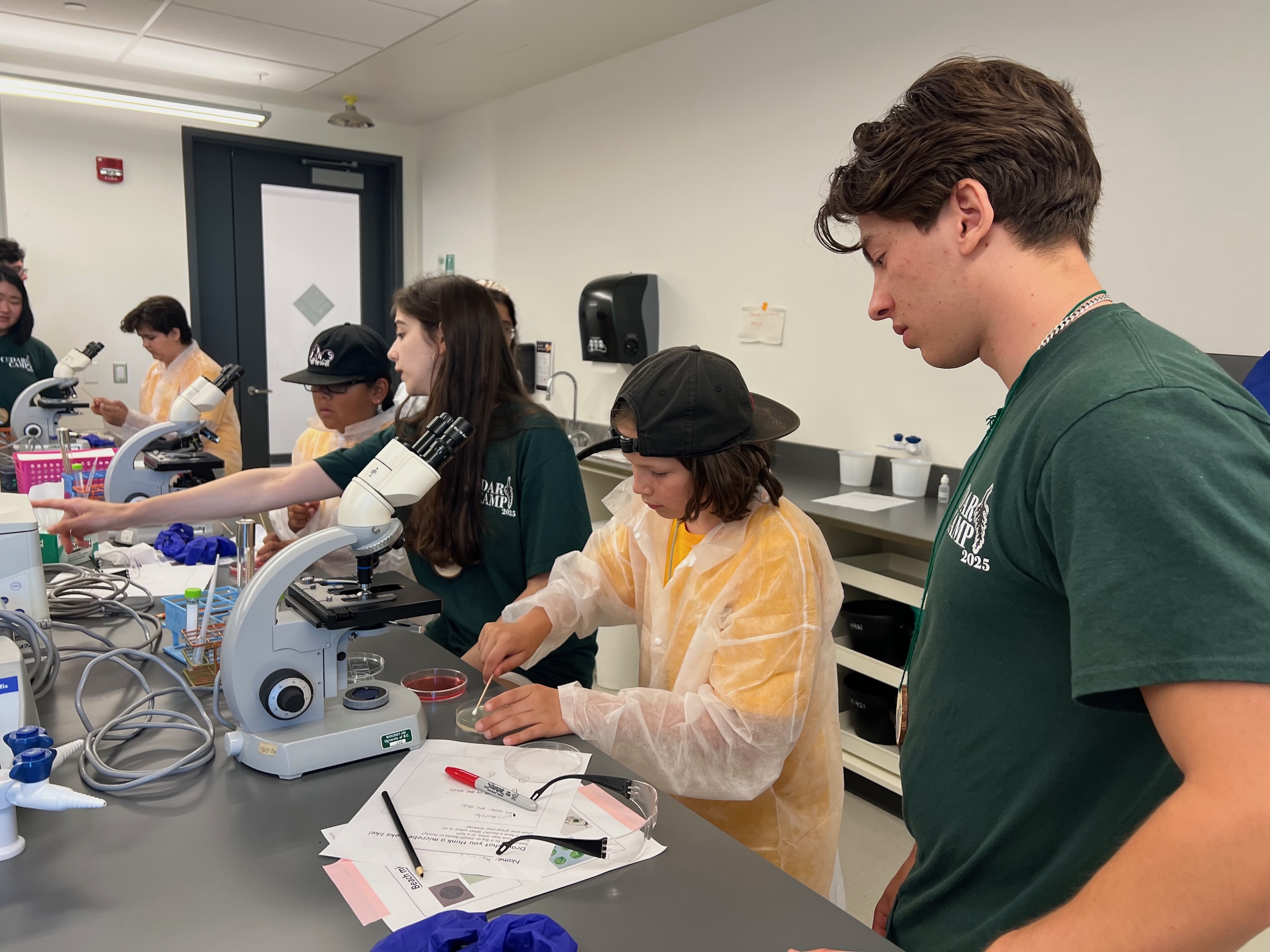 Campers swab Petri dishes