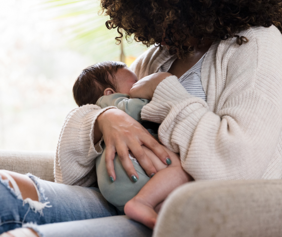 A mother holding a baby close to her chest. 