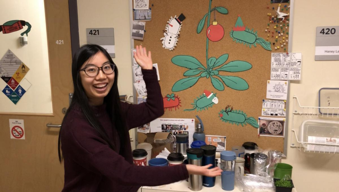 Nicole Wang in front of board with research on it,.